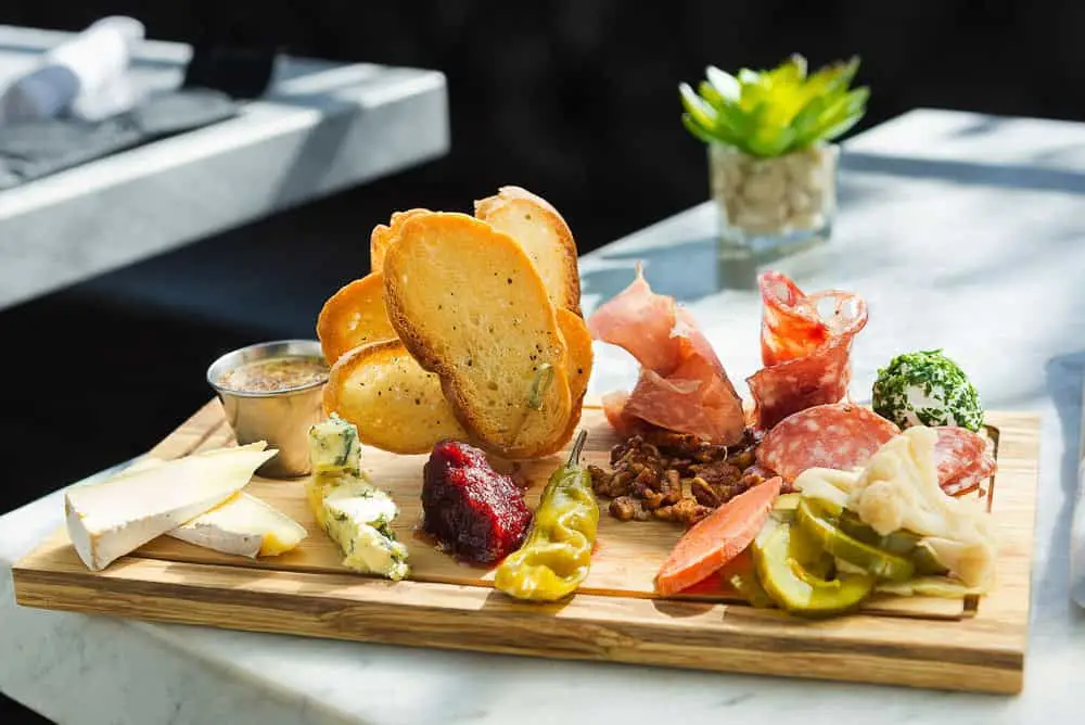 Charcuterie board with a variety of meats, cheeses, and accompaniments.