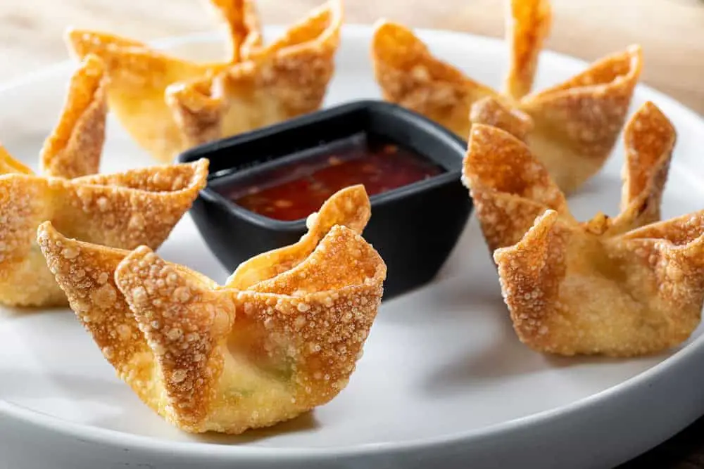 Close-up King Crab Wontons – Food Photography Detailed close-up of king crab wontons served with a rich dipping sauce.