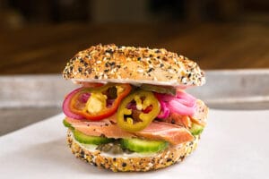 Everything bagel sandwich with smoked salmon, pickled onions, and jalapenos.